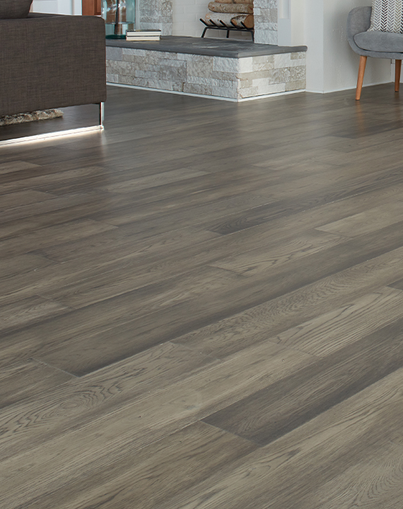 grey hardwood flooring in living room with fireplace