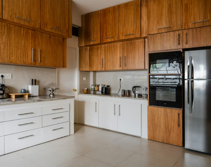Living room with soft grey and cream furniture and carpet.